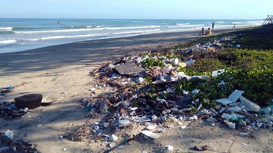 Plastic pollution on a beach highlights the pressing environmental concerns driving Italy’s proposed plastic tax, which faces another delay.