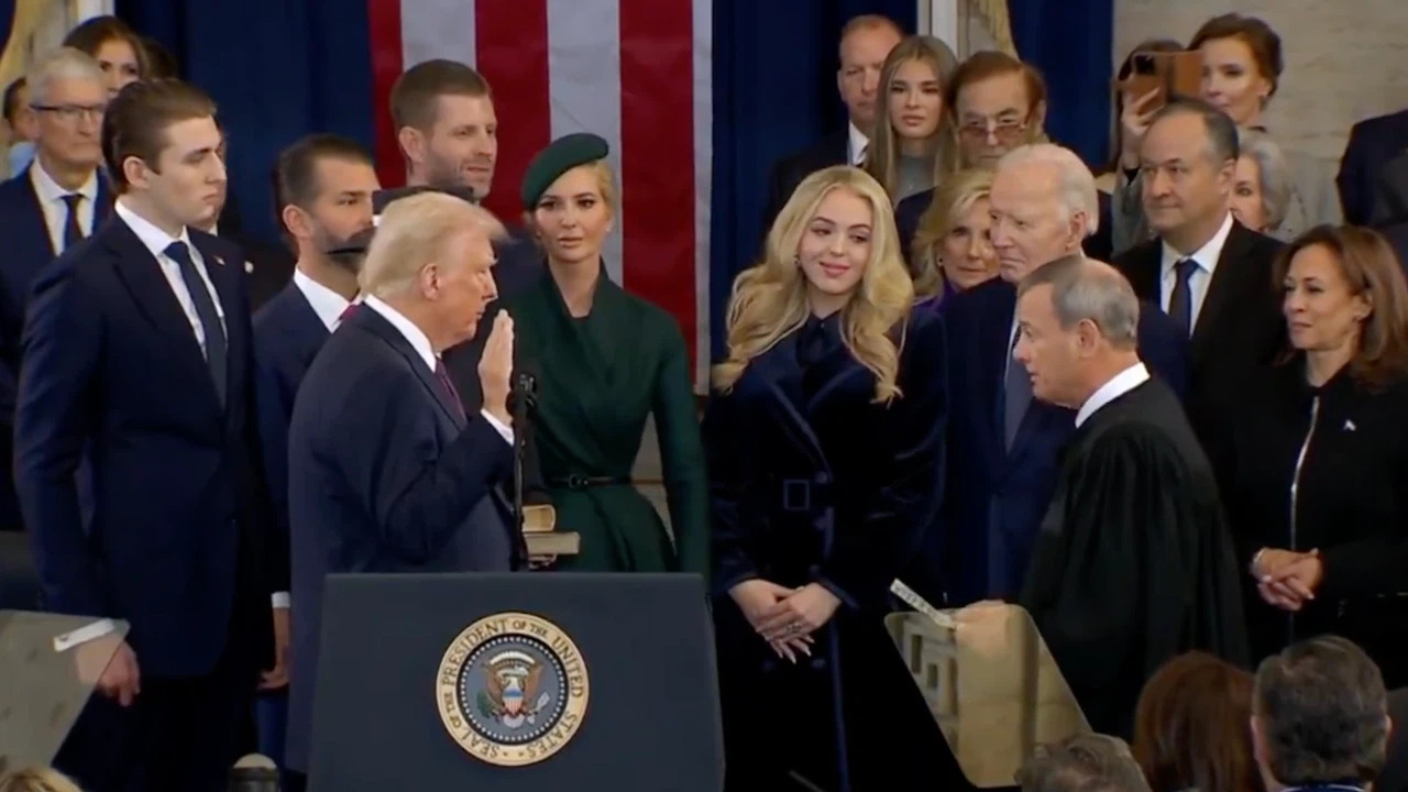 Donald Trump taking the presidential oath, symbolizing the beginning of the ‘America First’ trade policy, which aims to enhance U.S. economic growth and security.