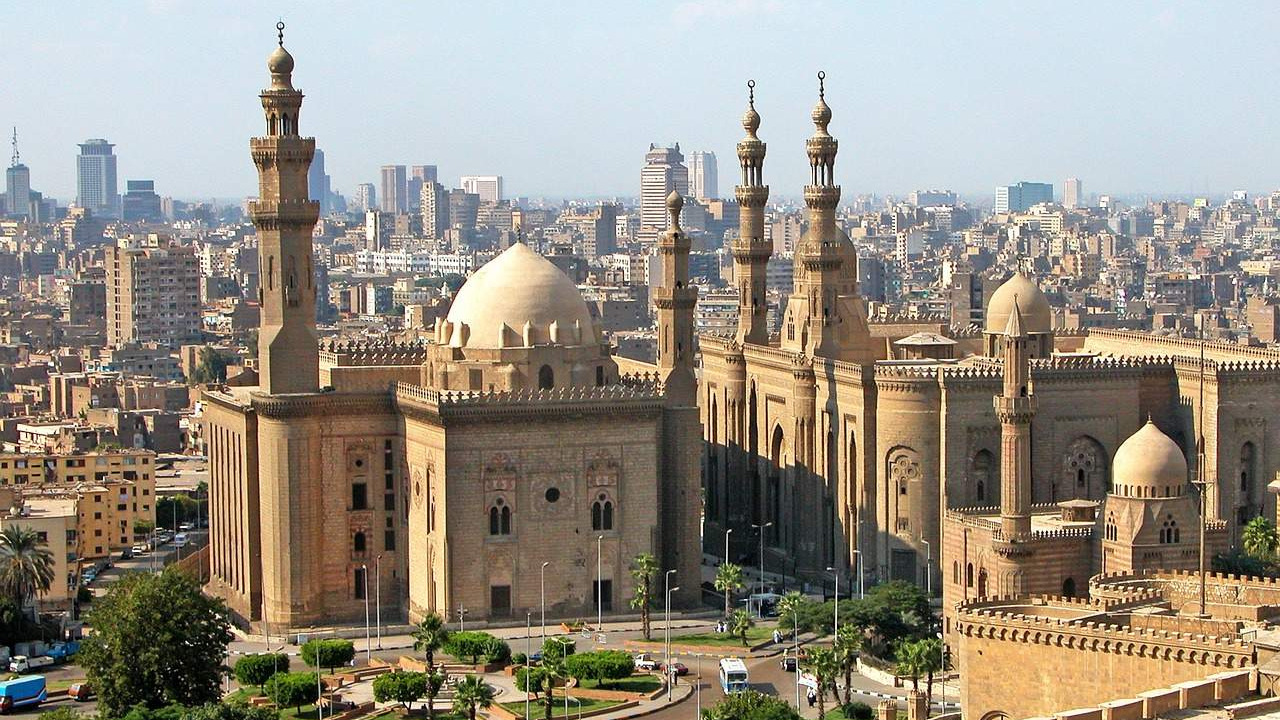 A panoramic view of Cairo, Egypt, featuring historic mosques and the modern skyline, representing the country’s evolving economic landscape.