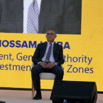 Dr. Rasha Abdel Aal, Dr. Hossam Heiba, and another panelist speak at RiseUp 2025 in front of a screen displaying the New Tax Facilitation Initiative.