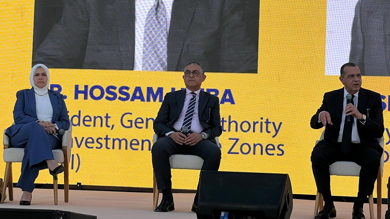 Dr. Rasha Abdel Aal, Dr. Hossam Heiba, and another panelist speak at RiseUp 2025 in front of a screen displaying the New Tax Facilitation Initiative.